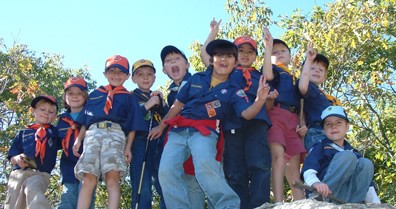 Cub scouts on a hike and waving